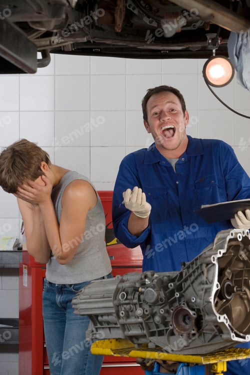 Preview: Middle-Aged Mechanic Is Cheering While A Young Woman Is Standing Next To Him With Her Head In Her