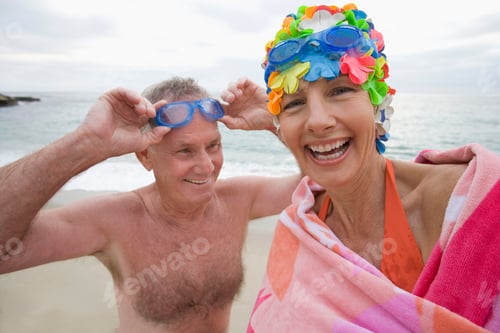 Preview: Smiling Portrait Of A Mature Woman In Swimming Costume And Cap By A Man With Goggles.