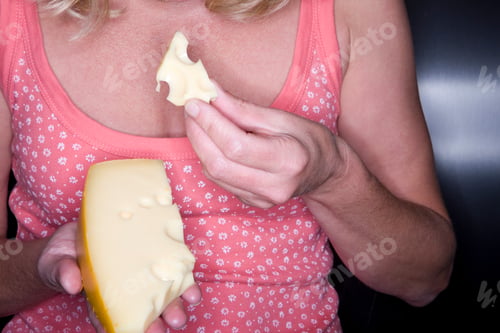 Preview: Close Up Of Middle Age Woman Holding And Eating Cheese