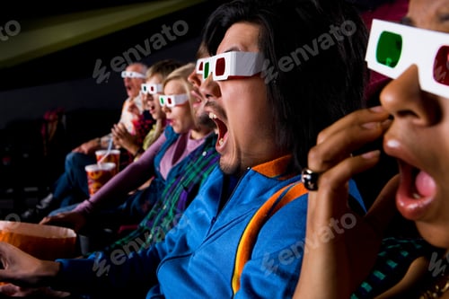 Preview: Horizontal Close-Up Shot Of An Audience In Cinema Hall Wearing 3D Glasses With Shocked Expression.