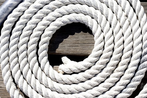 Preview: Vertical Close-Up Shot Of Coiled Rope On The Jetty.