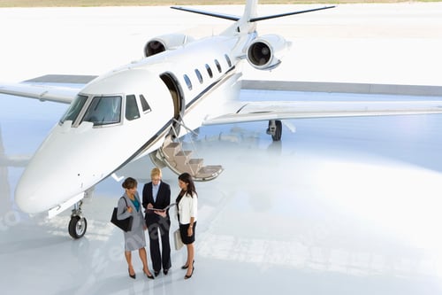 Preview: Horizontal Shot Of Three Businesswomen Posing In Front Of A Private Jet On The Runway.