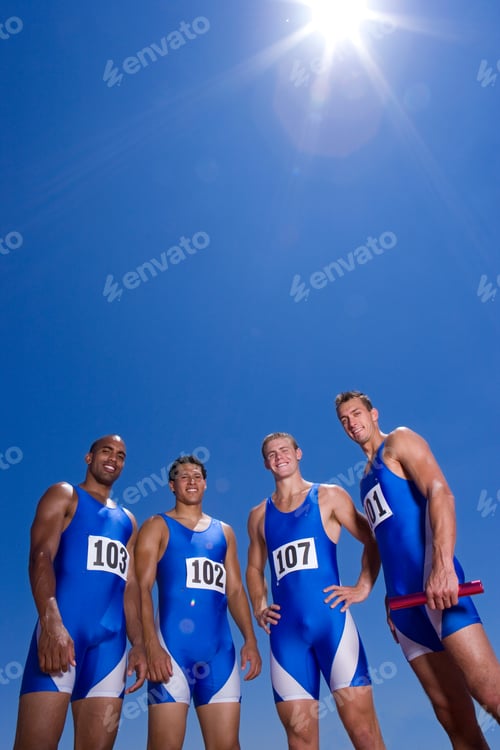 Preview: Young Male Athletes Posing And Smiling At The Camera On A Bright, Sunny Day At An Athletics