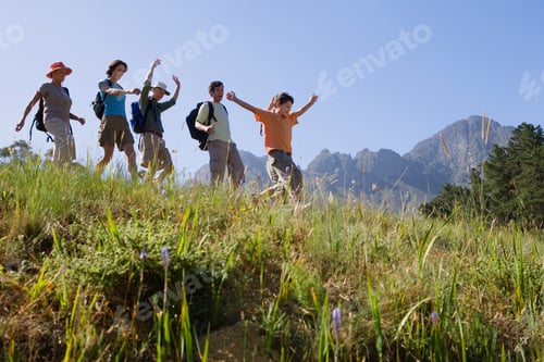Preview: Horizontal Low Angle Shot Of A Multi Generational Family Hiking Down A Mountain Trail With Copy