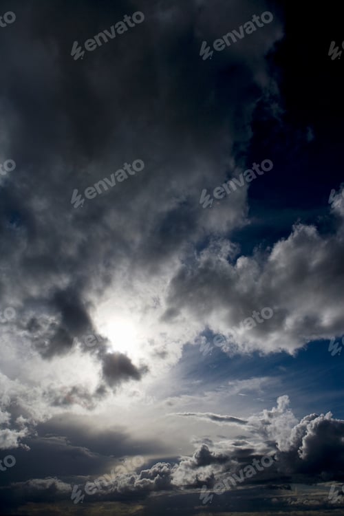 Preview: Natural Blue Sky With Fluffy Clouds Hiding The Sun Behind.