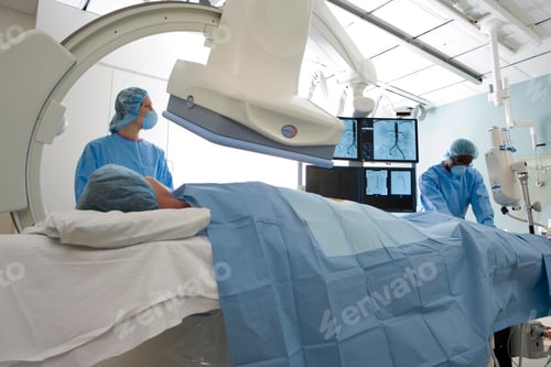 Preview: Horizontal Shot Of Doctors In Scrubs And Surgical Masks In Operation Room Scanning A Patient Lying