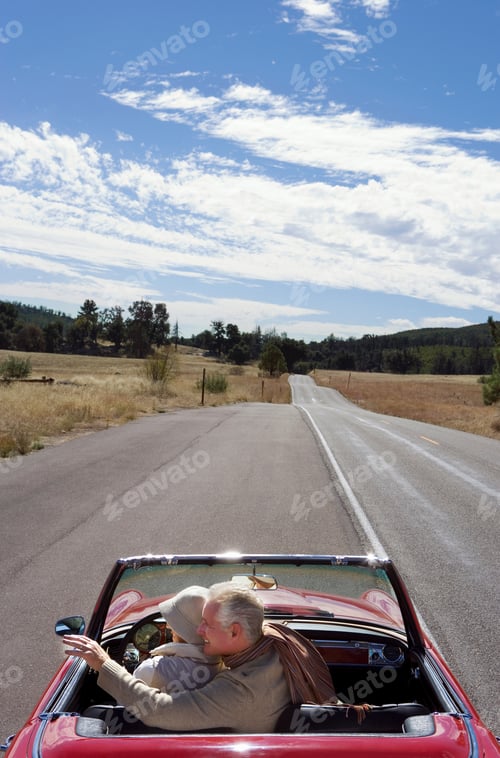 Preview: Vertical Rear View Of A Joyous Mature Couple On A Road Trip With The Man Pointing At Something On A