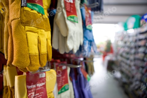 Preview: Close-Up Of Protective Gloves Hanging In A Shop With Copy Space.