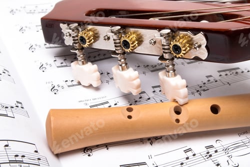 Preview: Guitar And Wooden Flute On Sheet Music. Close Up.