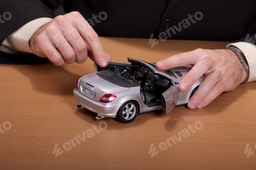 Preview: Businessman Playing With His Dream Car