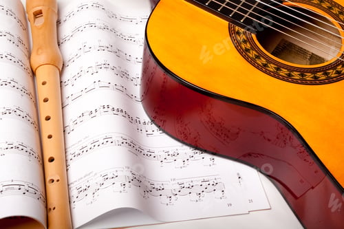 Preview: Wooden Flute And Classic Acoustic Guitar On Sheet Music. Close Up.
