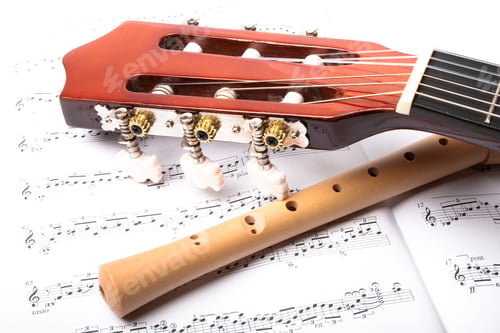Preview: Guitar And Wooden Flute On Sheet Music. Close Up.