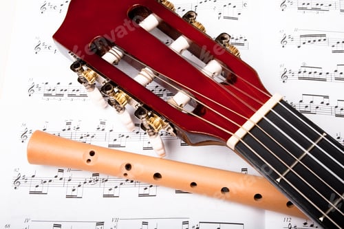 Preview: Guitar And Wooden Flute On Sheet Music. Close Up.