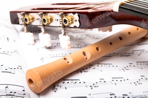 Preview: Guitar And Wooden Flute On Sheet Music. Close Up.