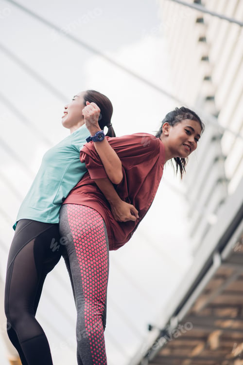 Preview: Sporty Asian Woman Warming Up For Run.