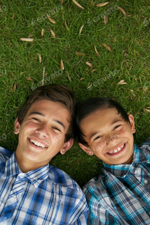 Preview: Happy Brothers Laying On The Grass.
