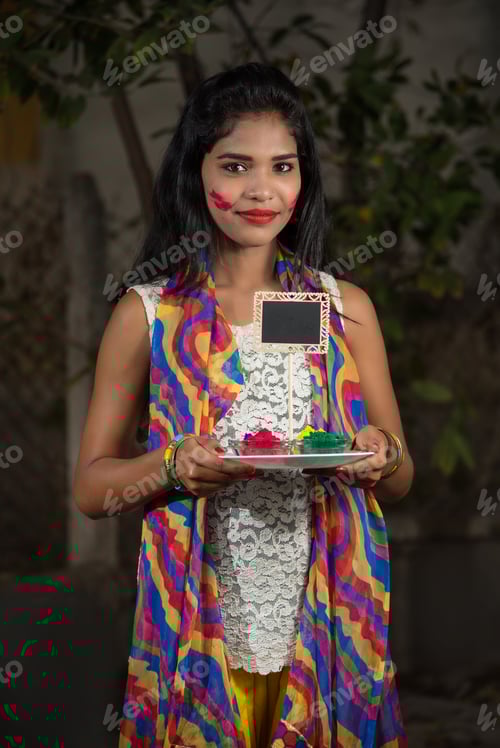 Preview: Young Girl Holding Small Board And Powdered Color On The Occasion Of Holi Festival.