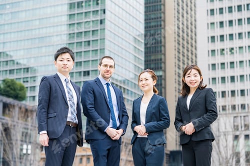 Preview: A Business Team Of Four Men And Women In Suits