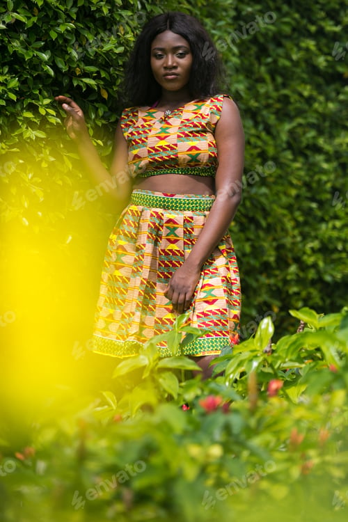 Preview: Woman In African-Print Dress In A Garden.
