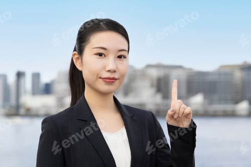 Preview: Young Asian Business Woman Pointing Her Index Finger