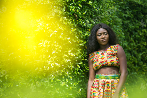Preview: Woman In African-Print Dress In A Garden.