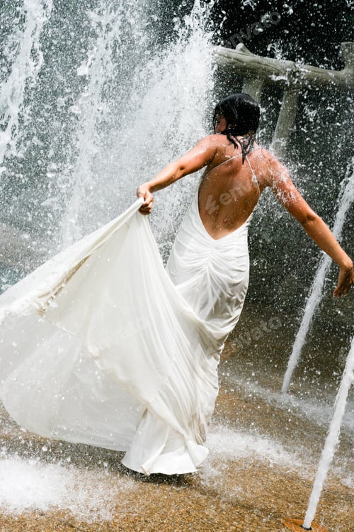 Preview: Beautiful Young Bride Playing In A Waterfall On Her Wedding Day.