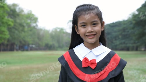 Preview: The Girl Wearing The Graduation Dress Stands Confidently In The Garden.