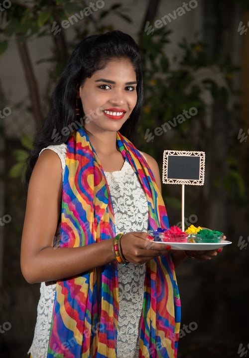 Preview: Young Girl Holding Powder Colors In Plate On The Festival Of Colors Called Holi, A Popular Hindu