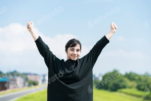 Preview: A Young Woman Showing A Relaxed Expression Under The Blue Sky