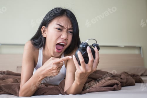 Preview: Happy Young Asian Woman Angry With Clock When Wake Up On Morning.
