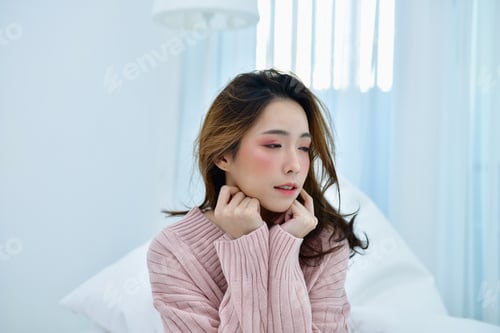 Preview: Winter Concept. Beautiful Woman Is Relaxing In Bedroom. Woman Wearing A Sweater In White Bedroom.