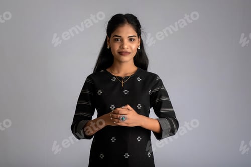 Preview: Portrait Of A Young Beautiful Cute Cheerful Girl Smiling Looking At The Camera On Gray Background