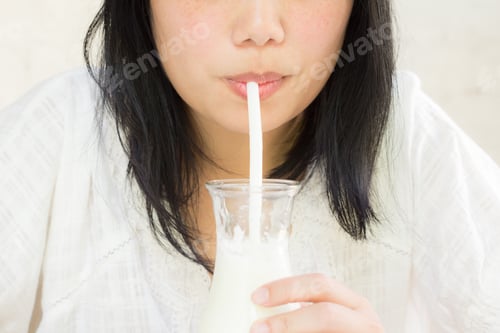 Preview: Lifestyle Of Woman Face Is Drinking Milk From Bottle Through The Straw. Asian Female Model Portrait