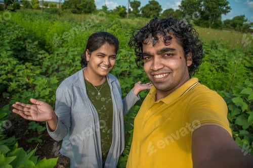 Preview: Young Farmer Couple Taking A Selfie With A Smartphone Or Camera In The Cotton Farm.