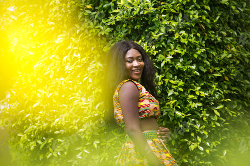 Preview: Woman In African-Print Dress In A Garden.