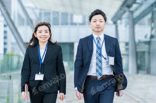 Preview: Businessman And Woman Walking Side By Side