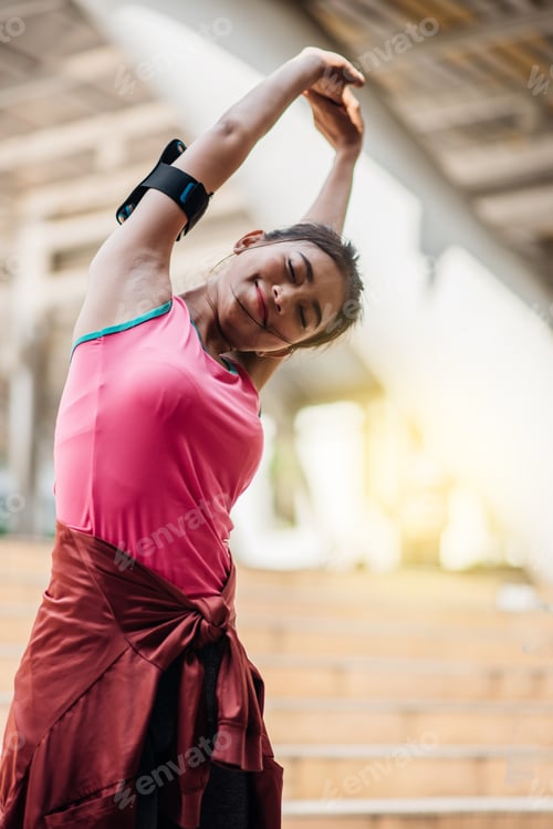 Preview: Sporty Asian Woman Warming Up For Run.