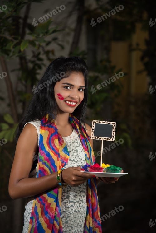 Preview: Young Girl Holding Small Board And Powdered Color On The Occasion Of Holi Festival.