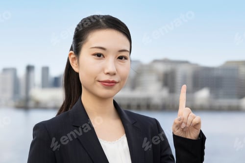 Preview: Young Asian Business Woman Pointing Her Index Finger
