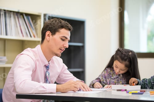 Preview: Portrait Of Teacher Teaching Children At Classroom Together, People With Education Concept.