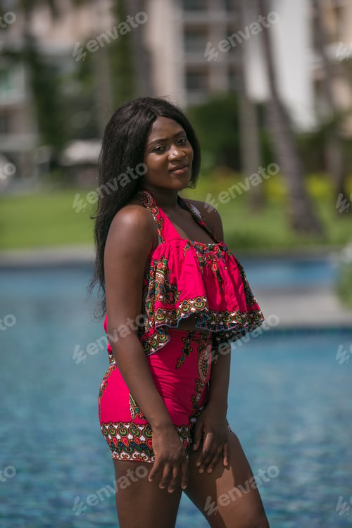 Preview: African Woman In Modern Dress Relaxing By The Pool.