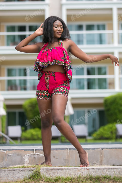 Preview: African Woman In Modern Ethnic Dress Relaxing At A Resort.