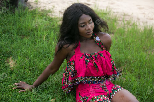 Preview: Woman In African-Print Dress In A Garden.