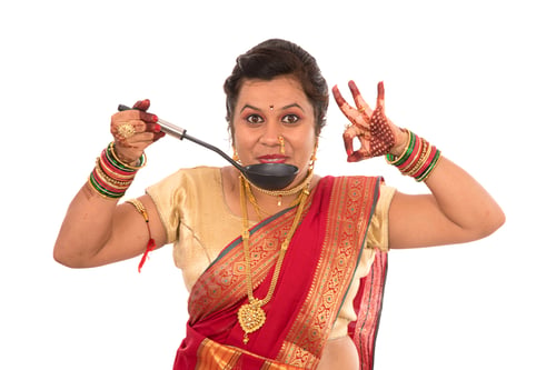 Preview: Young Traditional Indian Girl Holding Kitchen Utensil On White Background