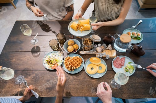 Preview: Scene Of A Home Party Where Men And Women Surround The Dining Table