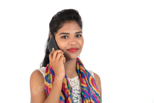 Preview: Young Indian Girl Using A Mobile Phone Or Smartphone Isolated On A White Background