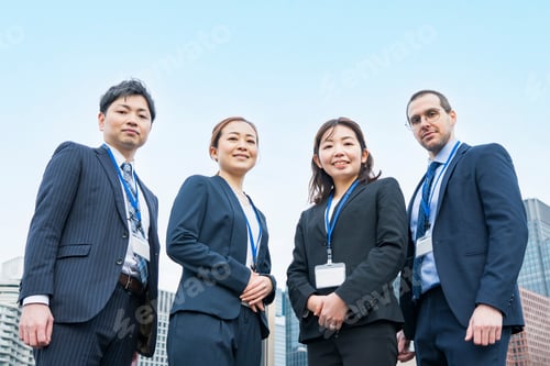 Preview: A Business Team Of Four Men And Women In Suits