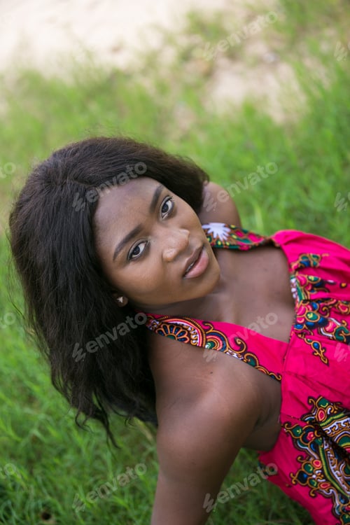 Preview: Woman In African-Print Dress In A Garden.