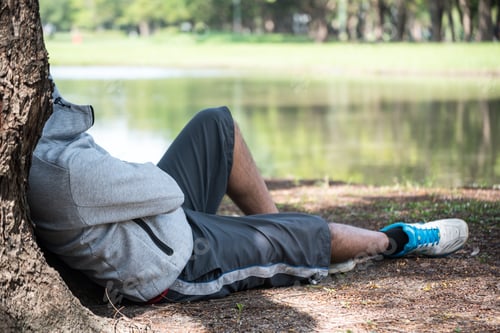 Preview: Asian Man Sleeping Under A Tree After Exercise.