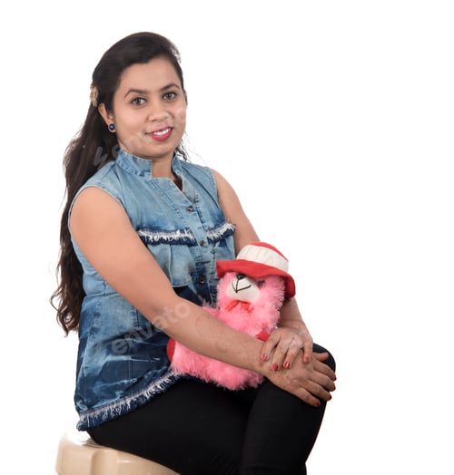 Preview: Beautiful Young Girl Holding And Playing With A Teddy Bear Toy On A White Background.